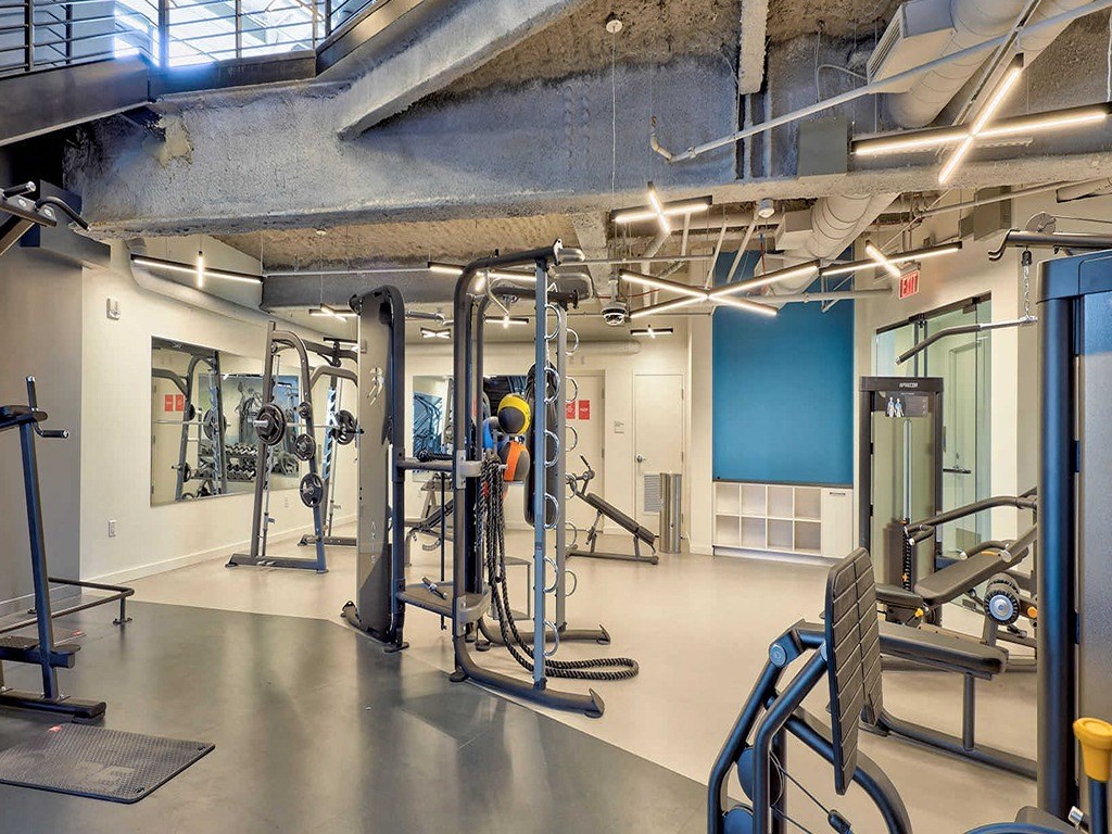 a gym with weights and other equipment in a building
